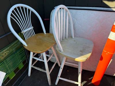 Two matching wooden chairs with white-painted backs and legs. 2